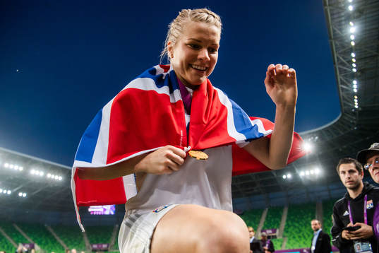 Ada Hegerberg of Lyon celebrates with a Norwegian flag