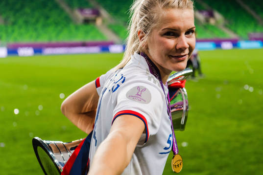 Ada Hegerberg of Lyon with her gold medal and the trophy