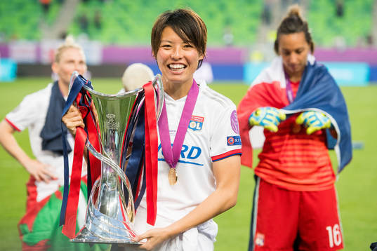 Saki Kumagai of Lyon poses with the trophy