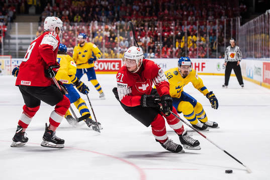 Kevin Fiala of Switzerland and Anton Lander of Sweden