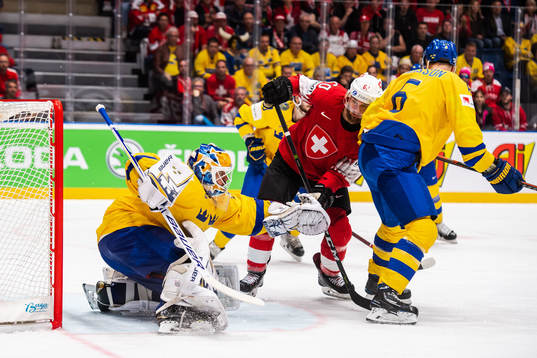 Goaltender Henrik Lundqvist of Sweden and Tristan Scherwey