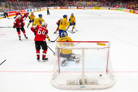 Gaetan Haas of Switzerland scores 3-3 behind goaltender