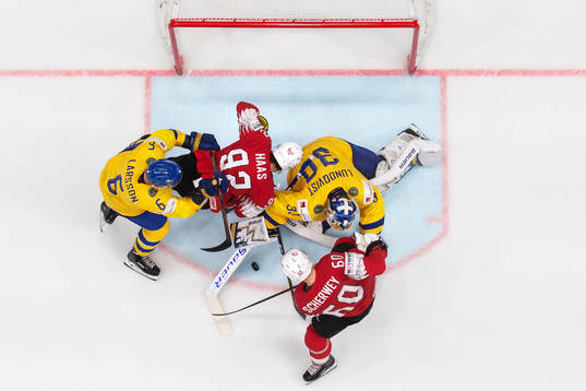 Adam Larsson and goaltender Henrik Lundqvist of Sweden in