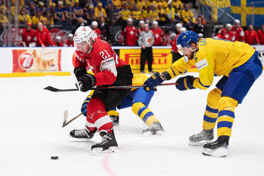 Kevin Fiala of Switzerland and Adam Larsson of Sweden
