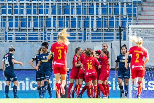 Katrine Winnem Jørgensen of Røa celebrate with teammates