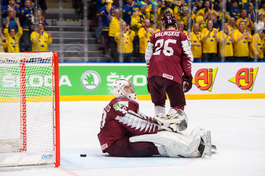 Goaltender Kristers Gudlevskis and Uvis Balinskis of Latvia