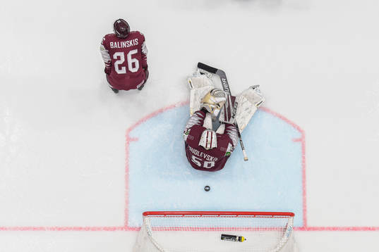 Uvis Balinskis and goaltender Kristers Gudlevskis of Latvia