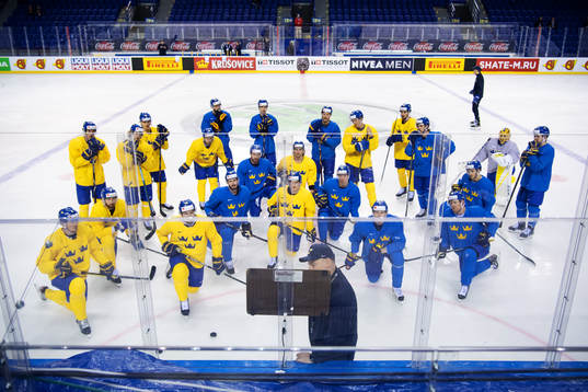 Players listen to head coach Rikard Grönborg of team