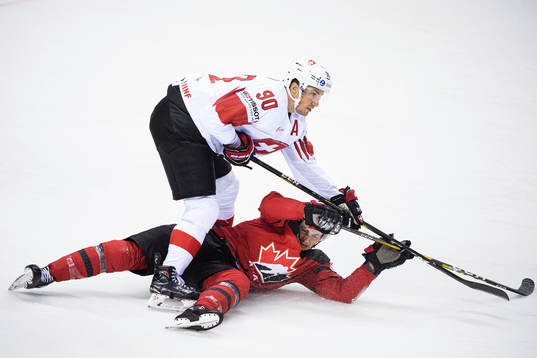 Roman Josi of Switzerland and Anthony Cirelli of Canada