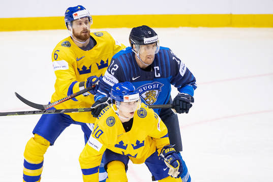 Adam Larsson and Elias Pettersson of Sweden in action