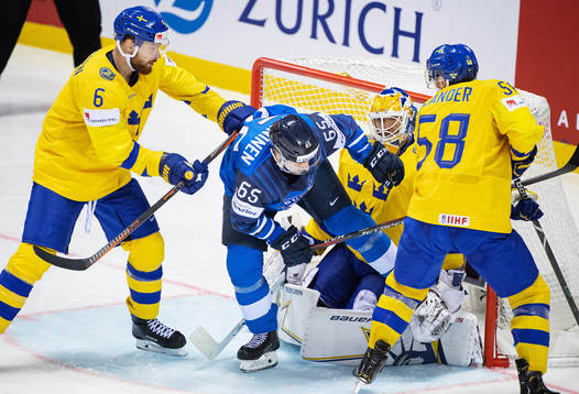 Sakari Manninen of Finland in action against Adam Larsson,