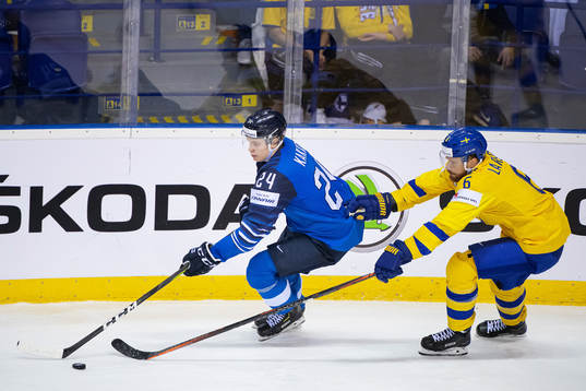 Kaapo Kakko of Finland and Adam Larsson of Sweden