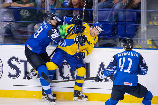 Patric Hörnqvist of Sweden is tackled by Jani Hakanpää