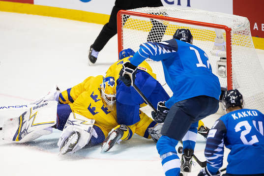 Marko Anttila of Finland scores 4-4 behind goaltender