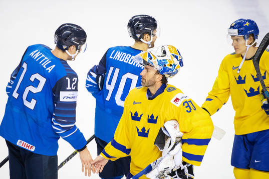 Marko Anttila of Finland and goaltender Henrik Lundqvist of