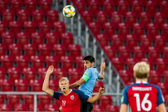 Erling Braut Haaland of Norway and Bruno Méndez of Uruguay