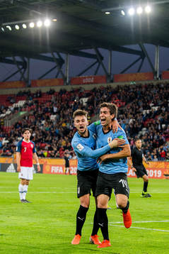 Francisco Ginella of Uruguay celebrates with teammate