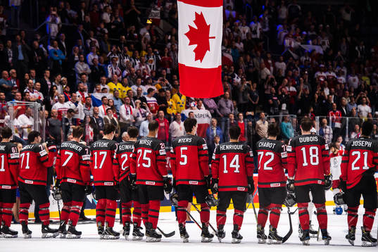 Players of Canada gathers in front of the Canadian flag