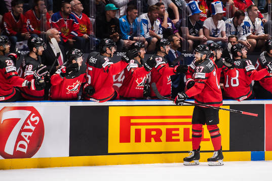 Shea Theodore of Canada celebrate with teammates