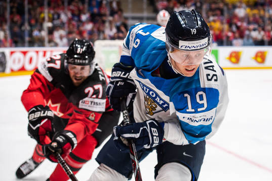 Shea Theodore of Canada and Veli-Matti Savinainen of Finland