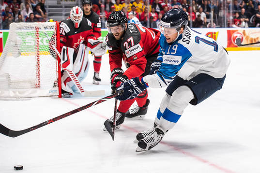Shea Theodore of Canada and Veli-Matti Savinainen of Finland