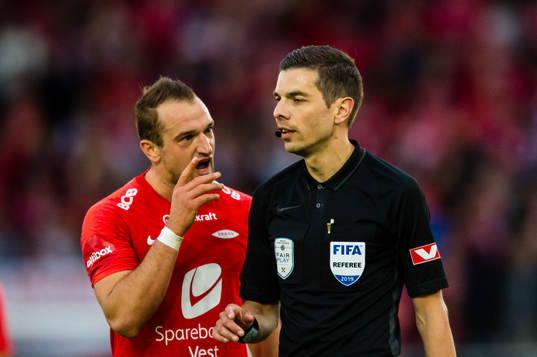 Veton Berisha of Brann and Tore Hansen, referee