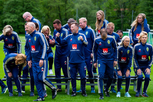 Staff leave a team photo shoot with coaching staff of the