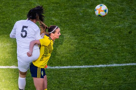 Doyeon Kim of South Korea and Kosovare Asllani of Sweden