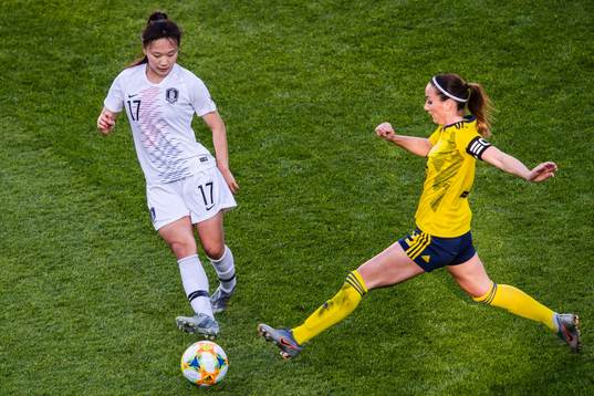 Geummin Lee of South Korea and Kosovare Asllani  of Sweden