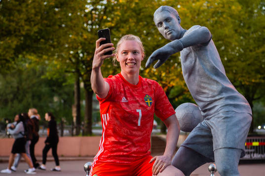 Goalkeeper Hedvig Lindahl of Sweden next to a statue of