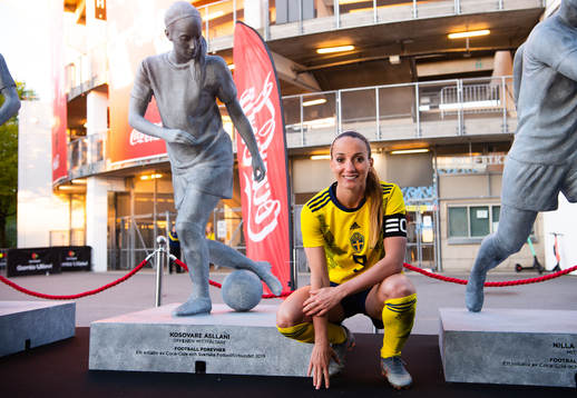 Kosovare Asllani of Sweden next to a statue of herself