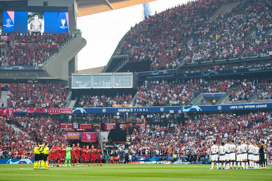 Players of Liverpool and of Tottenham observe a minute of