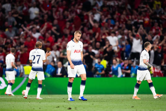 Eric Dier of Tottenham looks dejected Divock Origi of