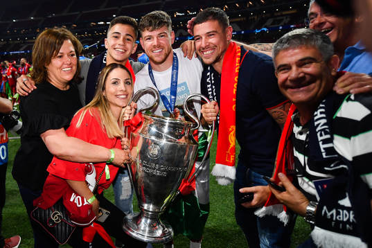 Alberto Moreno of Liverpool celebrate with the trophy