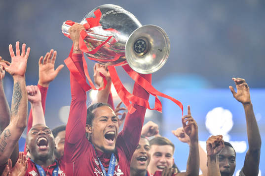 Virgil van Dijk of Liverpool celebrate with the trophy