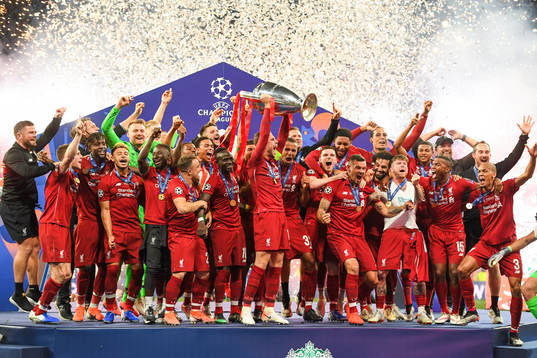 Players of Liverpool celebrate with the trophy