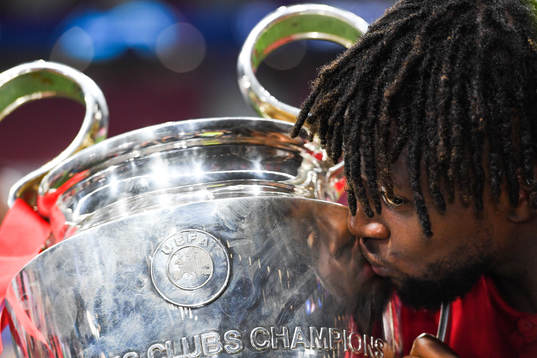 Divock Origi of Liverpool kisses the trophy as he celebrate