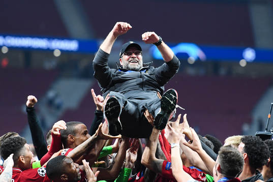 Head coach Jürgen Klopp of Liverpool is hoisted by the