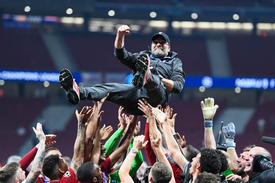 Head coach Jürgen Klopp of Liverpool is hoisted by the