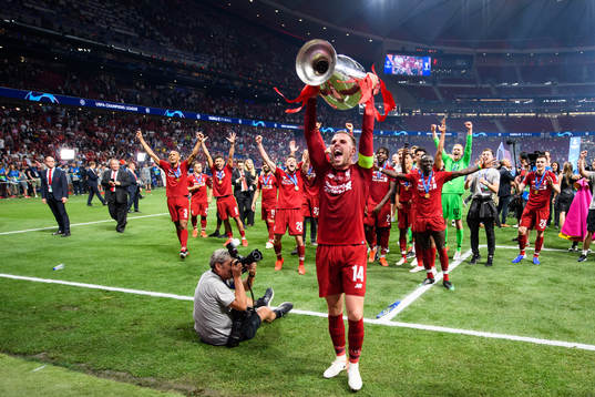 Jordan Henderson of Liverpool celebrates with the throphy