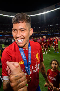 Roberto Firmino of Liverpool celebrating winning the UEFA