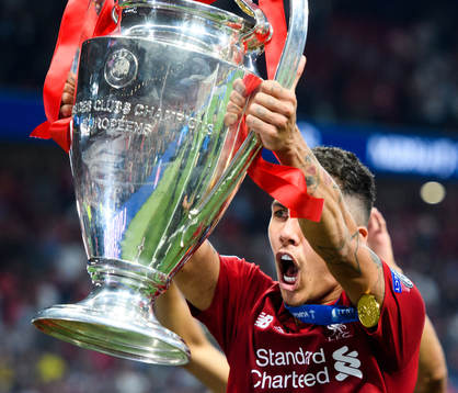 Roberto Firmino of Liverpool celebrates with the throphy