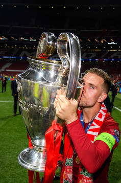 Jordan Henderson of Liverpool celebrates with the throphy