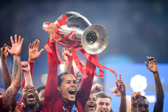 Virgil van Dijk of Liverpool celebrate with the trophy