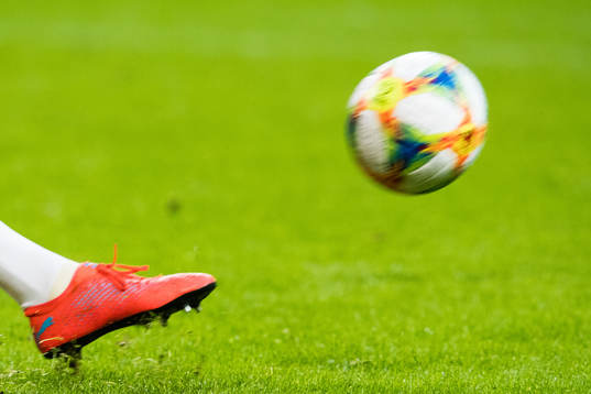 A player kicking the ball