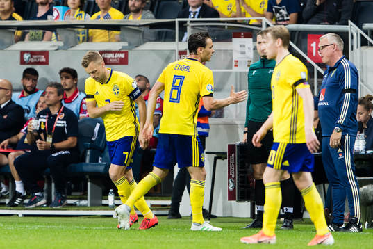 Sebastian Larsson changes with Albin Ekdal of Sweden