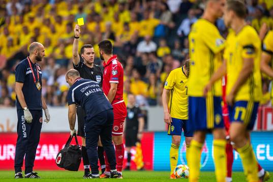Zach Muscat of Malta is shown a yellow card