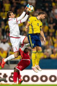 Goalkeeper Henry Bonello of Malta and Marcus Berg of Sweden