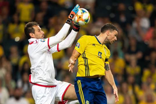 Goalkeeper Henry Bonello of Malta and Marcus Berg of Sweden