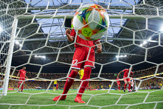 The ball is seen in front of Zach Muscat of Malta